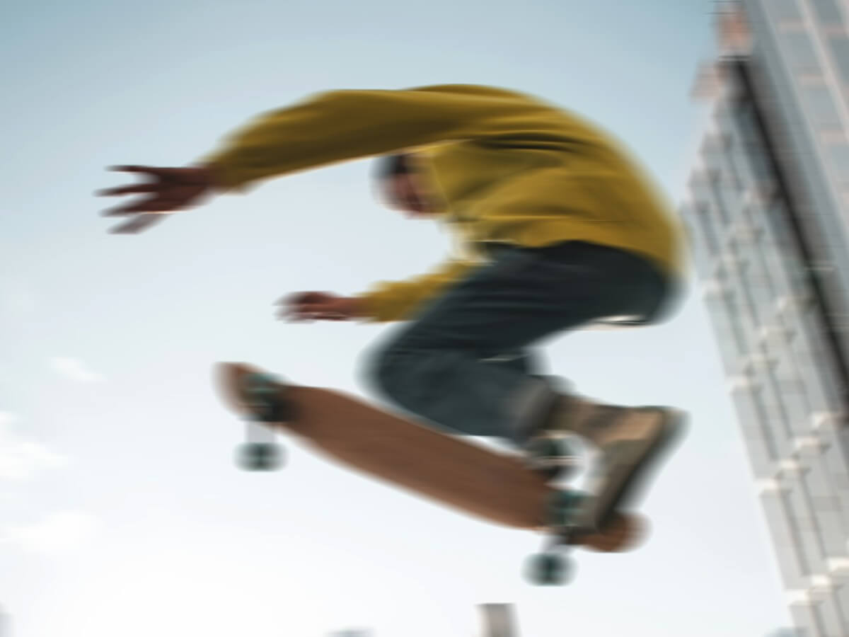 A blurry image of a person skateboarding