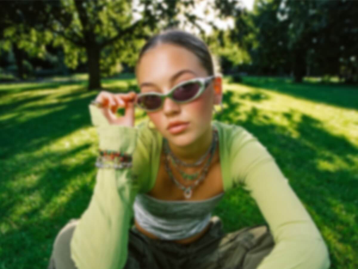 A blurry low quality image of a woman sitting on a forest meadow