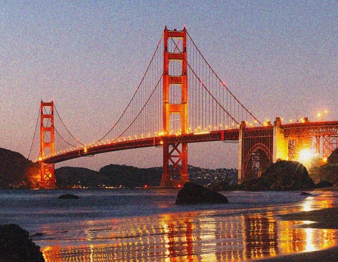 An original noisy photo of a bridge at night