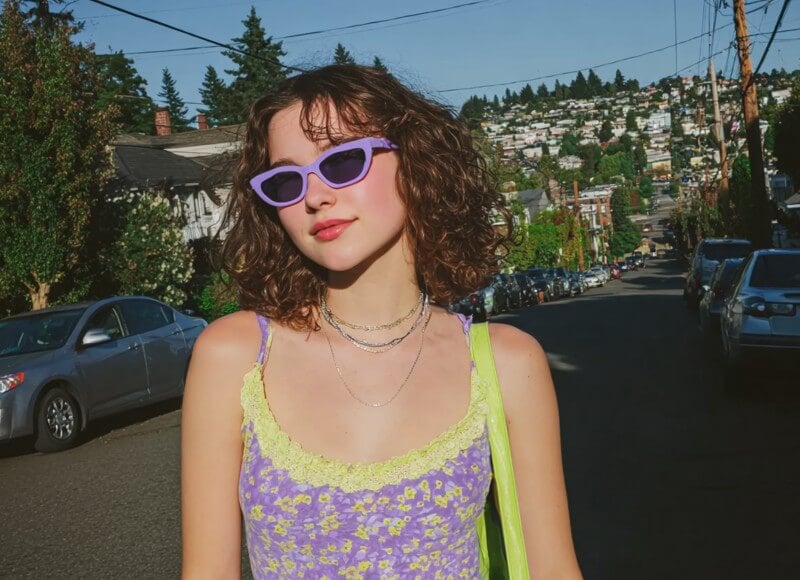 Portrait photo of a woman standing on a city street